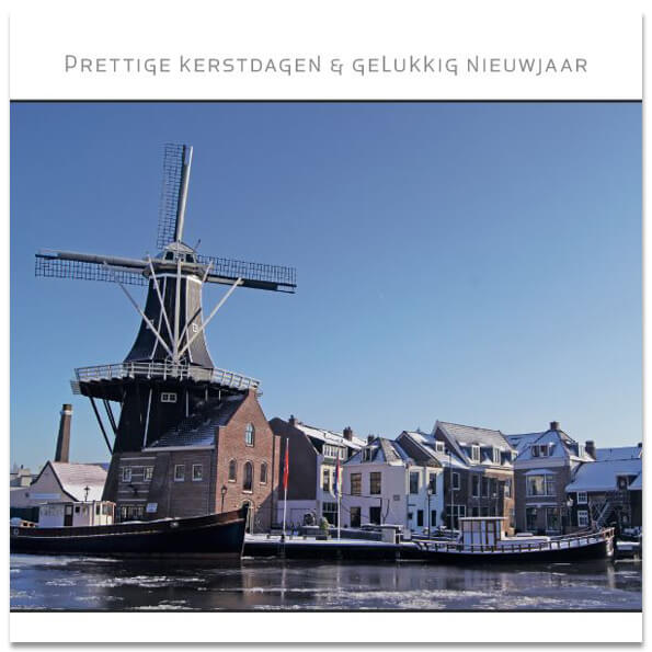 Haarlemse kerstkaart met Molen de Adriaan aan het Spaarne met ijs